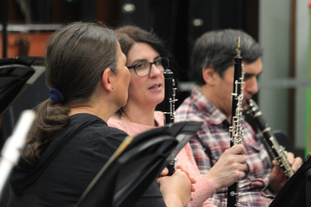 Three people playing clarinet