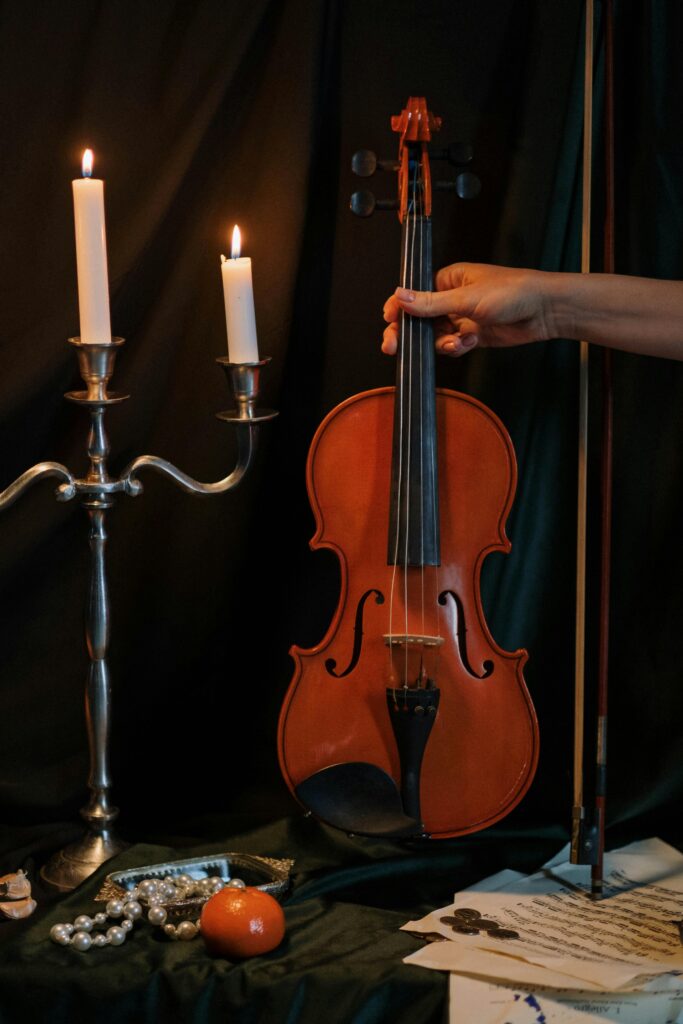 A violin next to a candle