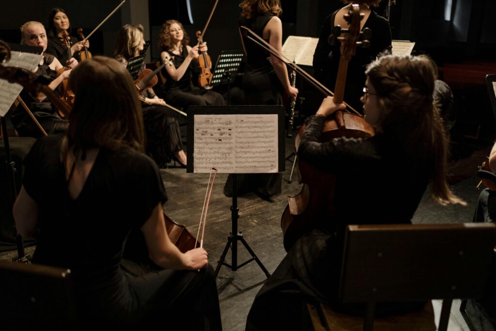 A group of women practicing string instruments